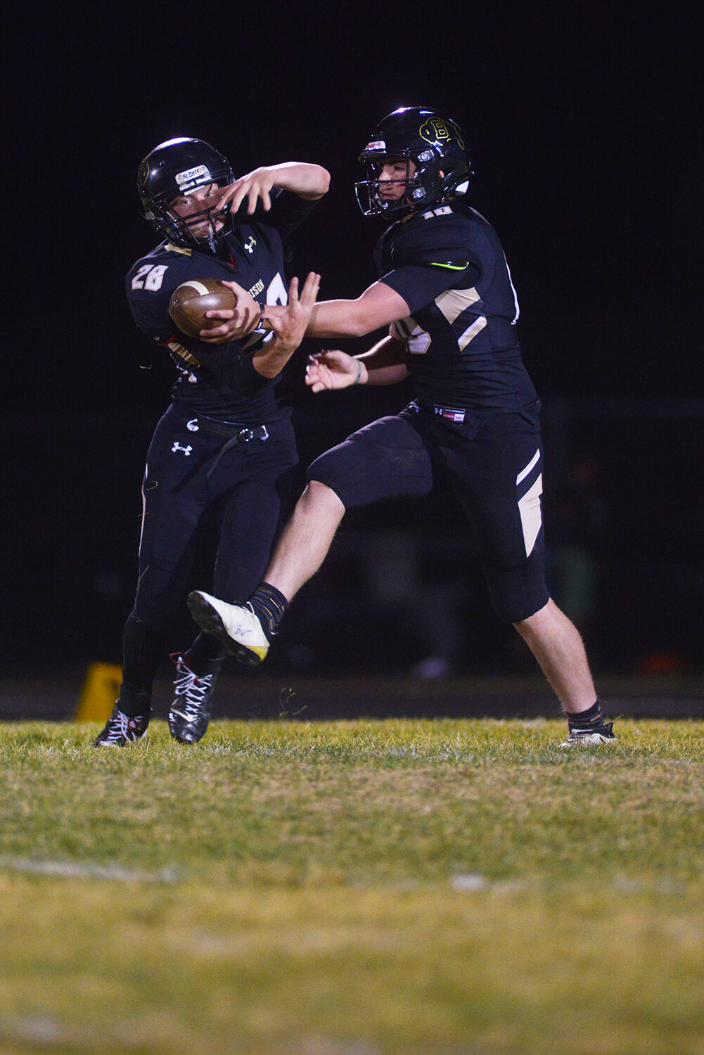Jackson Moon hands the ball off to running back Benjamin Camino